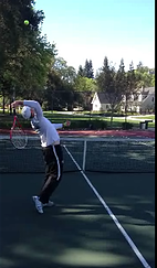 Client in training session hitting tennis ball with racket
